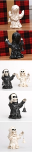 Close-up of Halloween resin skull ghost ornaments with hanging bells for spooky decor