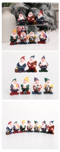 Detailed view of 7 resin garden dwarf figurines with gardening tools and welcome sign