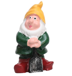 Macro detail of fairy tale gnome figurine with yellow hat and shovel for garden decor
