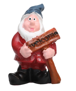 Detailed view of hand-painted garden gnome holding a welcome sign with wooden texture