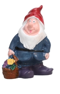 Detail of garden gnome resin figure with red hat and basket of yellow flowers