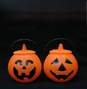 Detail of Halloween pumpkin buckets with handles and functional lids for storage