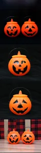Detail of orange Halloween pumpkin buckets with black handles and carved facial expressions