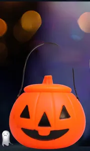 Close-up of a classic orange Halloween pumpkin lantern bucket with a black handle