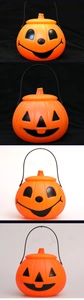 Detail view of plastic Halloween pumpkin buckets with different faces and black handles