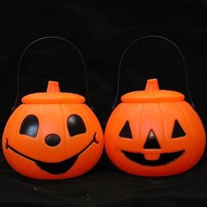 Set of two orange Halloween pumpkin lanterns with black handles and classic Jack-o'-lantern faces
