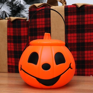 Classic orange Halloween pumpkin bucket with Jack-o'-lantern face and black handle