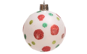 Macro detail of hand-painted white Christmas ball with red and green glitter dots