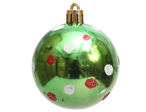 Detail of green 6cm Christmas bauble with red and white glitter dots on a white background