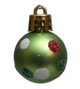 Green Christmas ball with red and white glitter dots and gold cap on white background