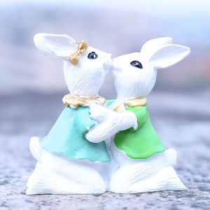 Resin Easter kissing bunny figurines in blue and green attire for home decor