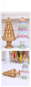 Detail of Easter resin cone tree featuring roses, daisies and colorful eggs on pedestal