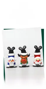 Three Christmas wind-up toys showing Santa, reindeer, and snowman in upside-down poses