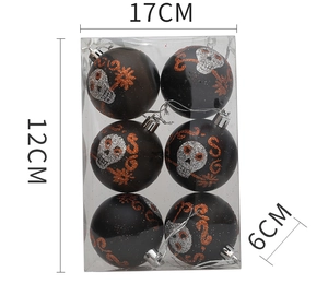 Detail of 6cm black Halloween ornaments with silver skulls and orange glitter in a PVC box