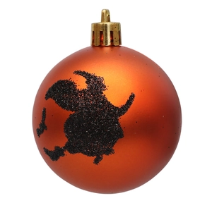 Detail of orange matte Halloween ball featuring black glitter witch on broom pattern