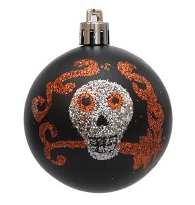 Close-up of matte black Halloween ornament with silver and orange sequin skull detail