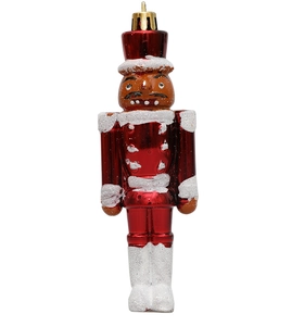 Detail eines roten Nussknacker-Anhängers mit Glitzer-Schneeflocken für den Weihnachtsbaum