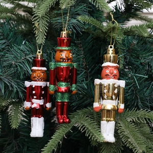 Drei Nussknacker-Soldaten-Anhänger mit Glitzer-Finish an einem grünen Weihnachtsbaum