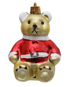 Detalle del oso de peluche navideño dorado con abrigo rojo y detalles de copos de nieve