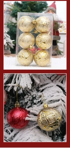 Détail de boules de Noël dorées de 6cm avec relief de maison sur des branches enneigées