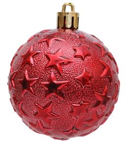 Close-up of red Christmas ball with embossed star texture and gold hanging loop
