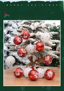 Detail of red and white 6cm Christmas ball ornaments hanging on a snowy Christmas tree