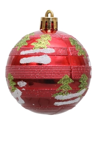 Detail of red Christmas ball ornament with green glitter tree and white snow patterns