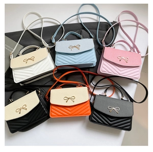 Top view of V-quilted handbags in six colors with golden bow hardware and PU leather texture