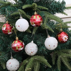 Set of 9 red and white Christmas balls with snowflake and star patterns on tree