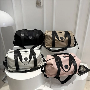 Waterproof oxford travel duffel bags in four colors displayed on a podium for gym use