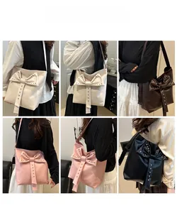 Detail of studded tote bags with large bows in beige, coffee, pink, and black colors