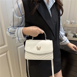 Chic white crossbody bag for women with metal butterfly decor and V-quilt pattern
