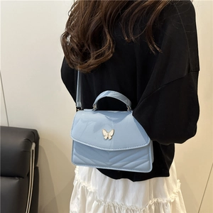 Chic light blue chevron quilted handbag with gold butterfly clasp and top handle