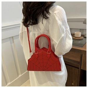 Detail of red semicircular handbag with black spider web embroidery and slim shoulder strap