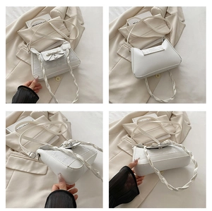 Detailansichten einer weißen Wolken-Tasche mit Blumenprägung, Schleife und Webgriff
