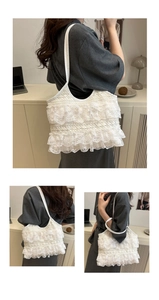 Detail view of the multi-layered lace ruffles and delicate fabric texture of the tote bag