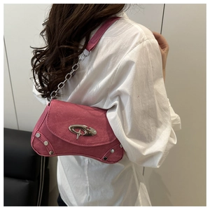 Detail of hot pink suede bag featuring silver metallic buckle and chunky chain strap