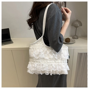 Detailed layered white lace ruffle tote bag worn on shoulder for elegant summer style