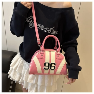 Detail of pink and white striped bowling bag with 96 embroidery shown as crossbody