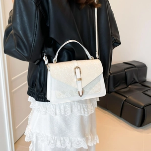 White snakeskin textured flap handbag with gold metal strap detail and shoulder strap