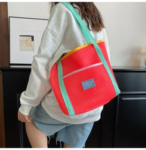 Mesh beach tote bag with red body, mint green straps and vibrant yellow trim detail