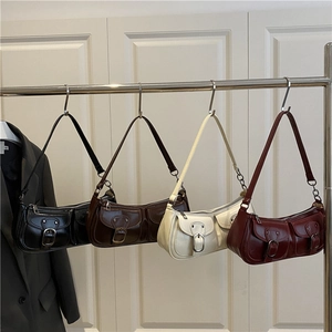 Retro shoulder bags in black, caramel, cream, and burgundy with double pocket details