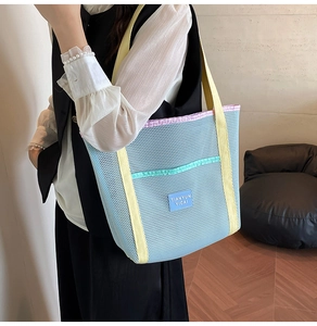 Fashionable mesh beach bag with multi-color straps and a spacious blue see-through design