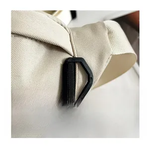 Close-up of beige water-resistant nylon fabric and durable black D-ring buckle