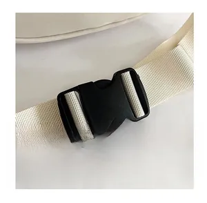 Detail of durable black plastic buckle on heavy-duty cream nylon shoulder strap webbing