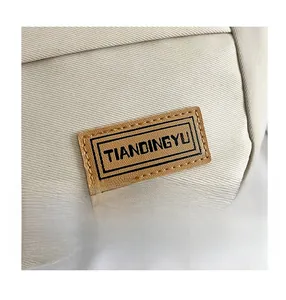 Detailed view of the brand leather logo and durable nylon fabric texture on crossbody bag
