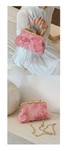 Detailed view of pink 3D floral petals on the elegant metal frame handbag