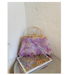 Detail of purple pleated floral evening bag with vintage gold handle and chain strap