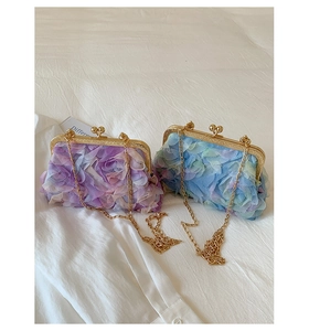Detailed macro view of gradient purple and blue floral textured petal evening handbags