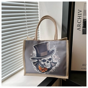 Detail of Halloween skull canvas tote bag featuring premium burlap texture and handle